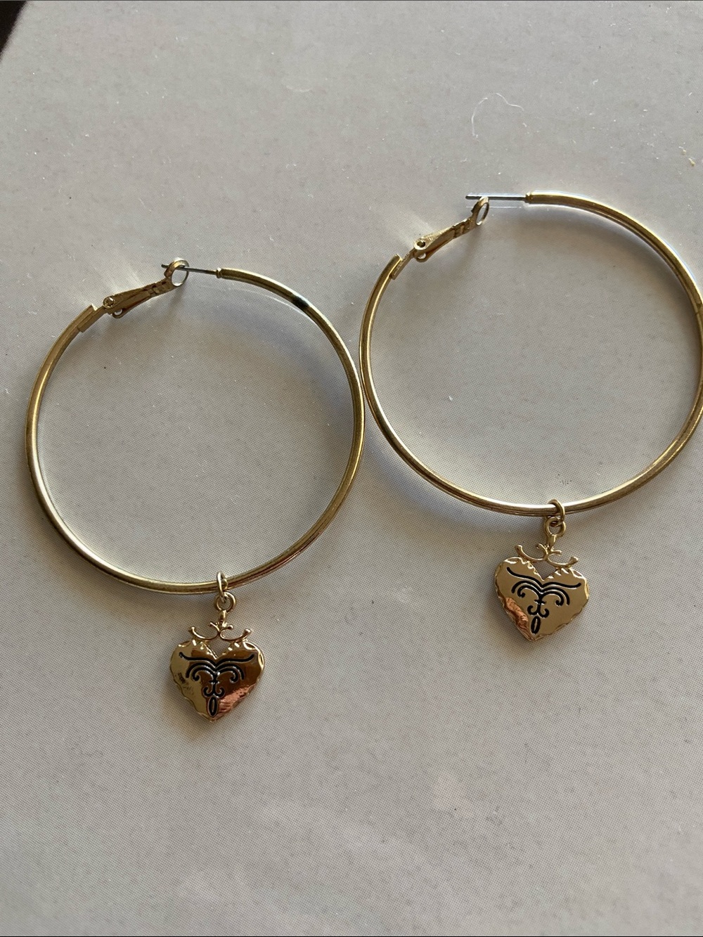 Medium sized hoop earrings with dangly heart